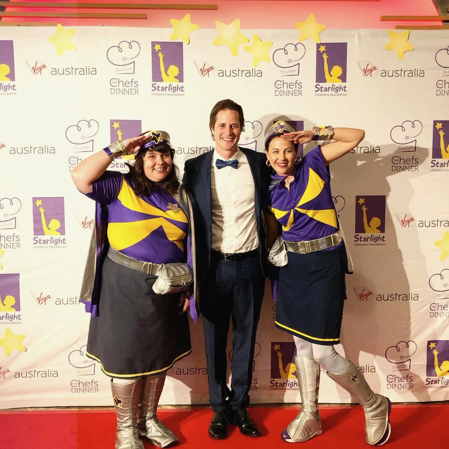 Ross Wallman on stage at a charity fundraising event