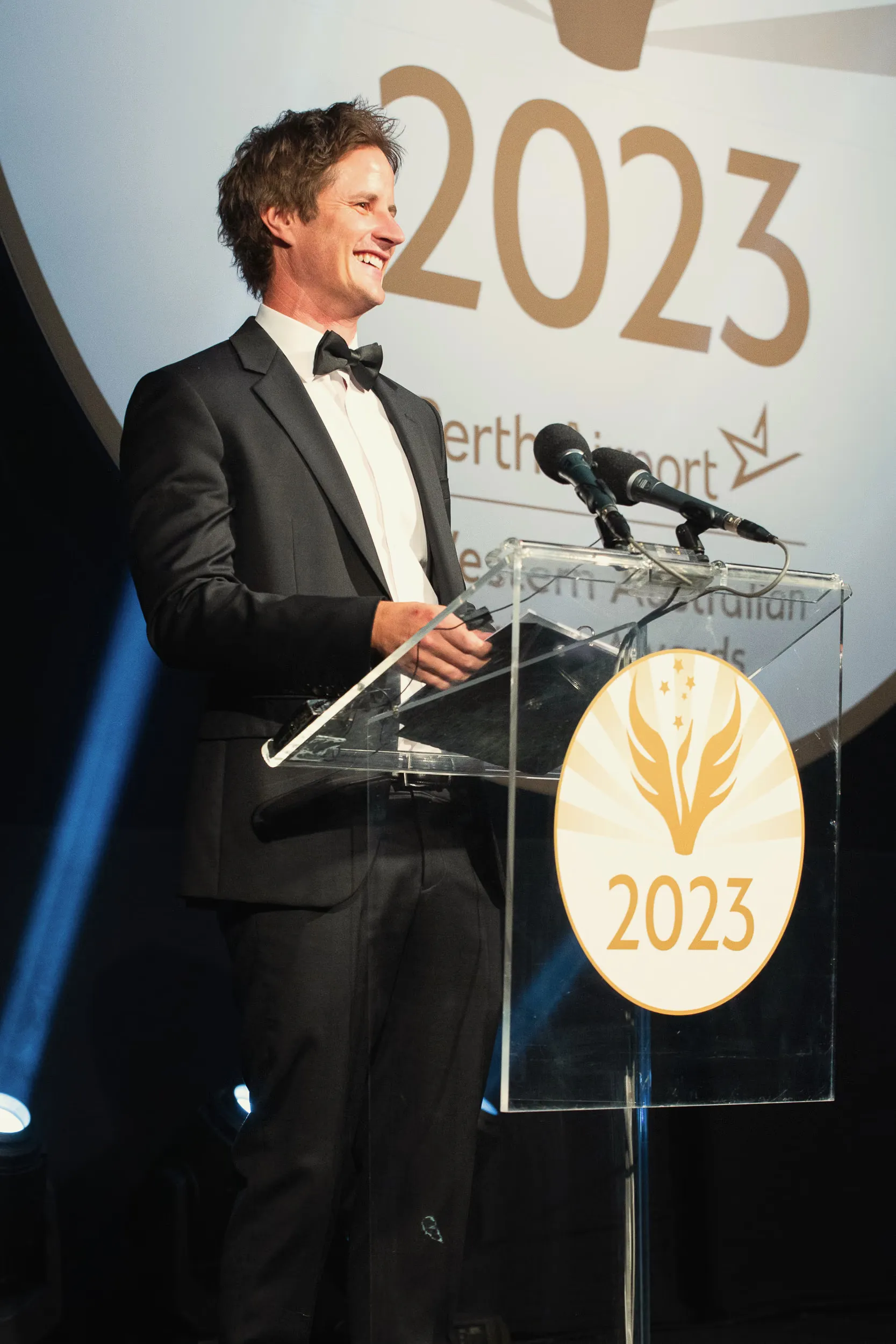 Ross Wallman hosting at a gala dinner podium